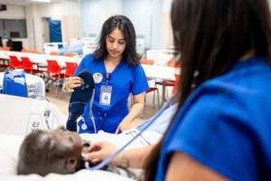 MSU Denver nursing students Marisa Schreiner, L, listens to lung sounds with a fellow student, Jimena Malta on Aug. 12, 2024, at the Simulation and Skills Laboratory.